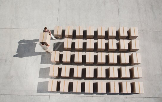 Mehrere Kartons von oben Fotografiert auf grauem Boden.